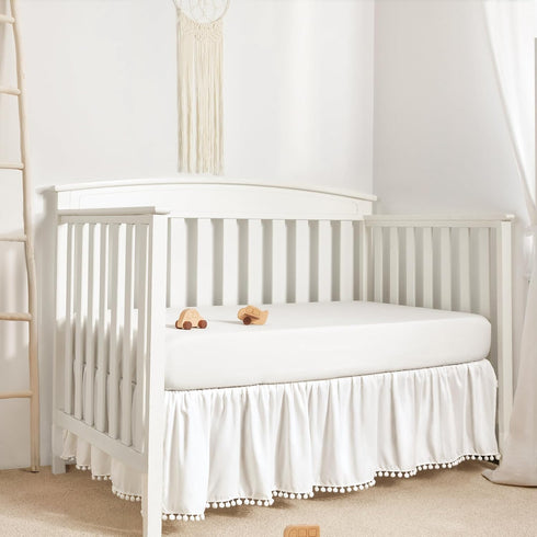 TILLYOU Ruffled Baby Crib Skirt with Pompoms, 28”x 52”, 14'' Drop, White for Girls and Boys