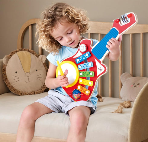 Hape 6-in-1 Music Maker - Colorful Guitar Shaped Musical Toy with 6 Instruments for Ages 18 Months+