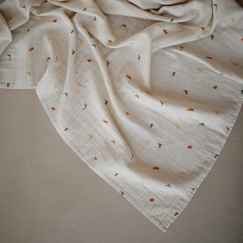 mushie Muslin Baby Swaddle Blanket | 100% Organic Cotton (Dinosaurs) by mushie