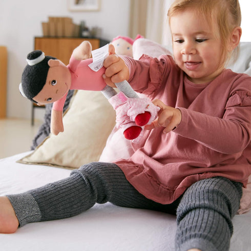 HABA Snug Up Doll Rumbi, 10" Soft Doll with Black Hair and Pink Overalls, Machine Washable for 18 Months and Up