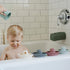 mushie Bath Spout Cover | Soft Silicone Bathtub Faucet Safety Guard for Kids | Universal Fit (Dried Thyme)