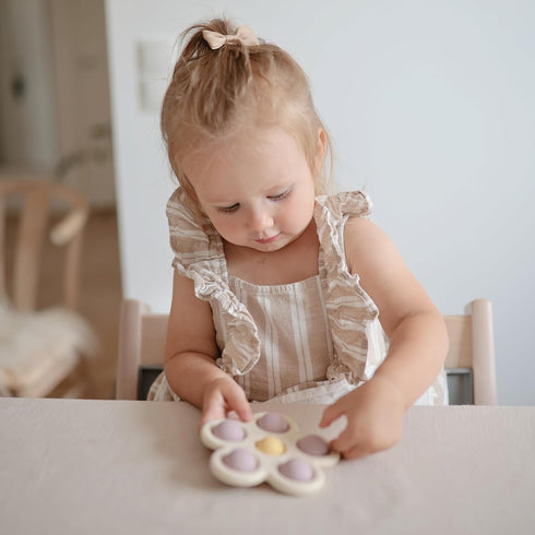 mushie Flower Press Toy in Soft Lilac, Daffodil, and Ivory