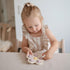 mushie Flower Press Toy in Soft Lilac, Daffodil, and Ivory