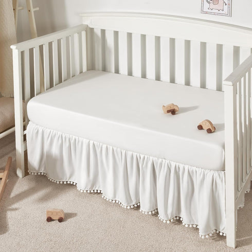 TILLYOU Ruffled Baby Crib Skirt with Pompoms, 28”x 52”, 14'' Drop, White for Girls and Boys