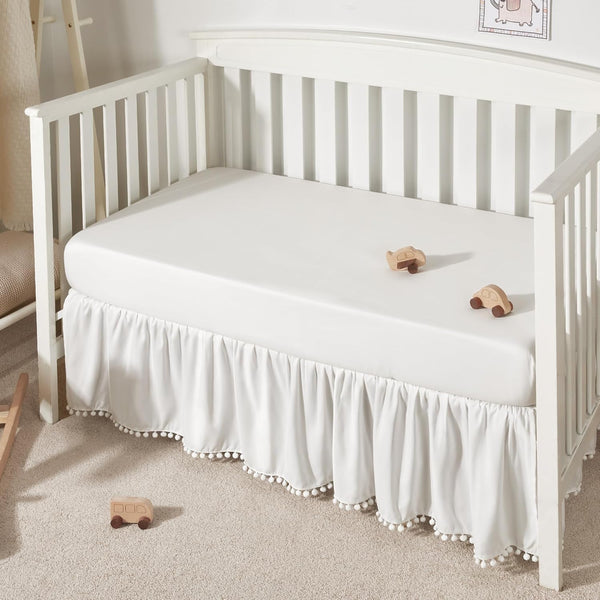 TILLYOU Ruffled Baby Crib Skirt with Pompoms, 28”x 52”, 14'' Drop, White for Girls and Boys