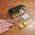 EKKZ 1:6 Set Scale Miniature Black Briefcase with Fake Gold Bars, Mini Dollar Bill Bundles, Vintage Coins & Toy Weapons